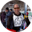 Skier holding skis and poles at a snowy winter resort