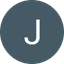 White letter J inside a dark circular background
